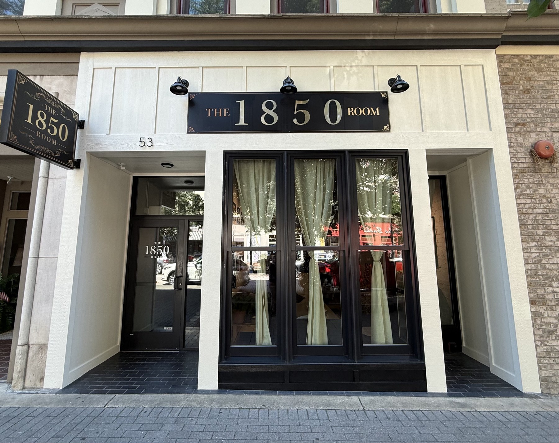 The 1850 Room front entrance and black-and-gold signage